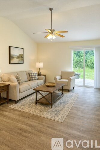 A living room with a couch, chair, and coffee table.
