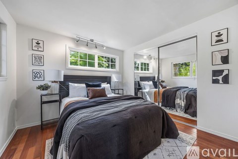 A bedroom with a large bed and a mirror on the wall.