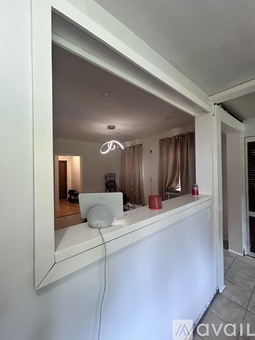 A white bathroom vanity with a mirror and a white sink.