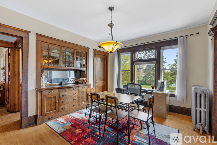 A kitchen with a table and chairs in front of a window.
