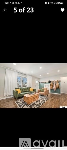 A living room with a green sofa and a wooden coffee table.