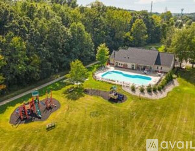 A backyard with a pool and a playground.