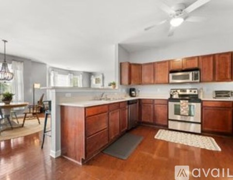 A kitchen with wooden cabinets and a white countertop.