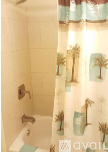 A shower curtain with palm trees on it.