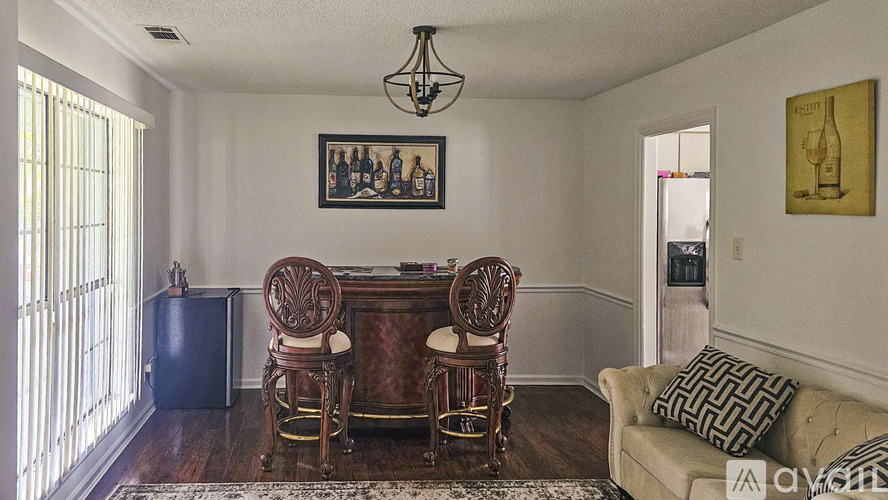 A dining room with a wooden table and chairs.