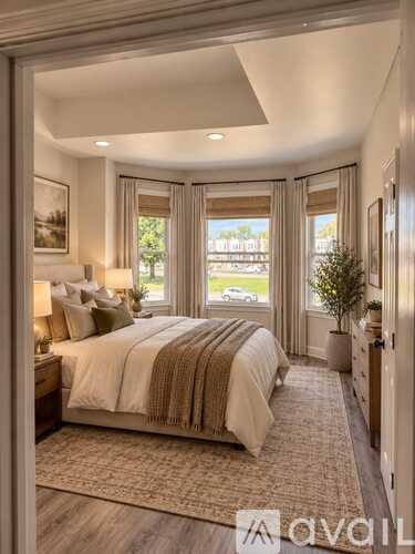 A bedroom with a large bed and a view of the outside.