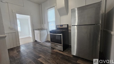 A kitchen with a stainless steel refrigerator and oven.