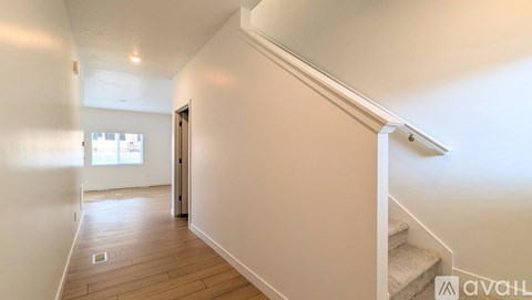 A hallway with a staircase leading to the second floor.