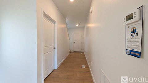 A hallway with a Titan sign on the wall.