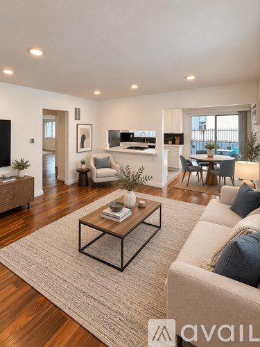A living room with a beige sofa, a coffee table, and a flat-screen TV.