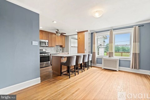 A kitchen with a dining table and chairs is available for rent.
