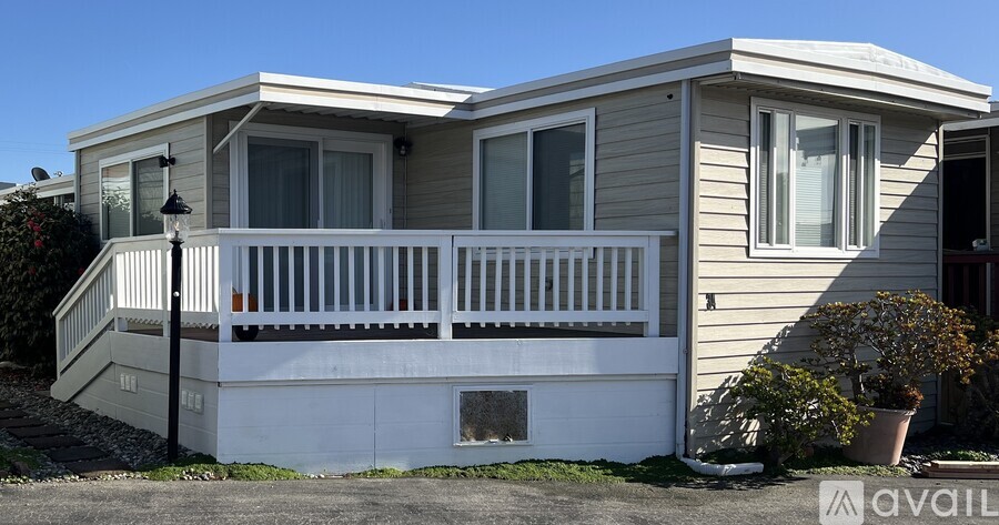 A two-story house with a balcony and a porch.