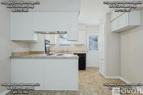 A kitchen with a counter and cabinets is shown in the image.