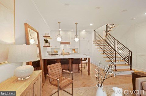 A well-lit, modern dining area with a wooden table and chairs.