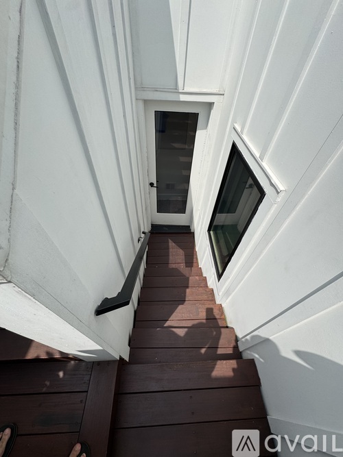 A white building with a small window and a door.