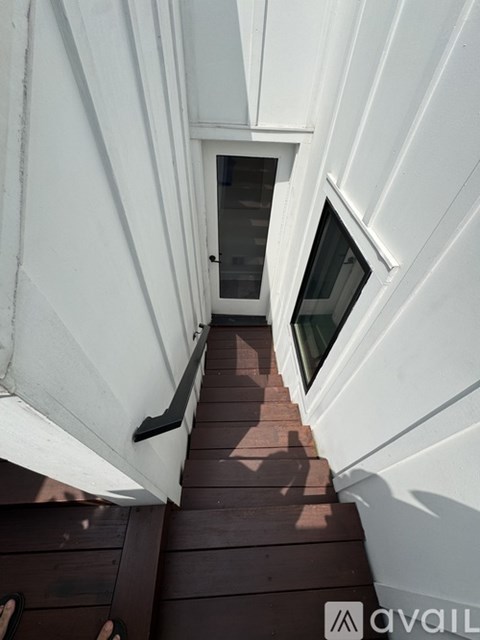 A white building with a small window and a door.