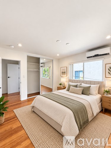 A bedroom with a large bed and a window.