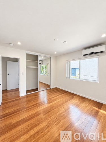A room with wooden floors and a window.