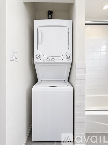 A white washing machine in a small laundry room.