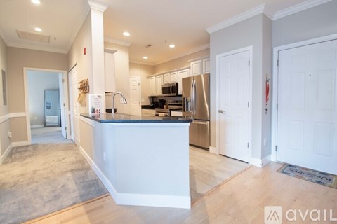 A kitchen with white cabinets and a large island.