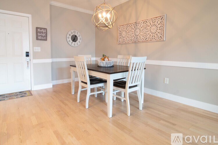 A dining room with a wooden table and chairs.