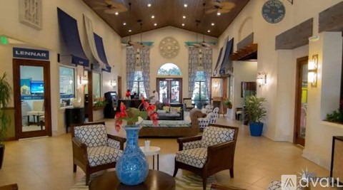 A blue vase sits on a table in a spacious lobby.