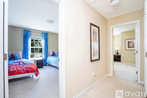 A bedroom with a bed and a picture on the wall.
