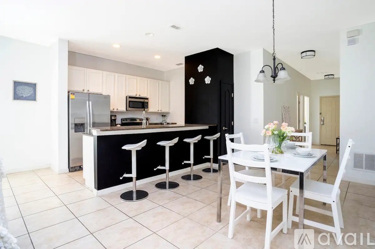 A kitchen with a bar area and a dining table.