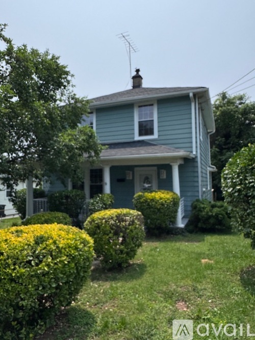 A house with a blue exterior and a white window.