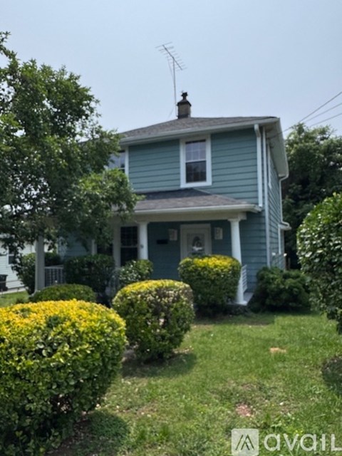 A house with a blue exterior and a white window.