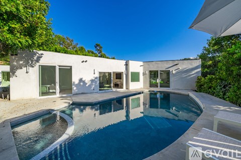 A modern house with a pool in the backyard.