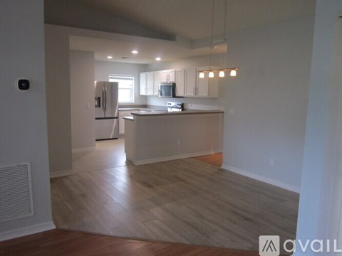 A kitchen with a refrigerator, microwave, and oven is available for rent.