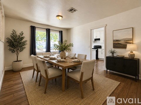 A dining room with a wooden table and chairs.