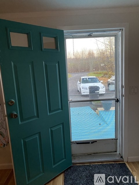 A car is parked in a driveway outside a house.