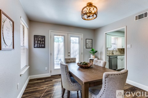 A dining room with a wooden table and chairs.