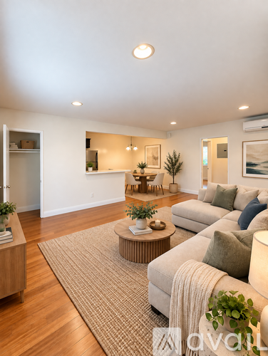 A living room with a white couch and a wooden coffee table.