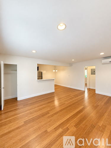 A room with wooden floors and white walls.