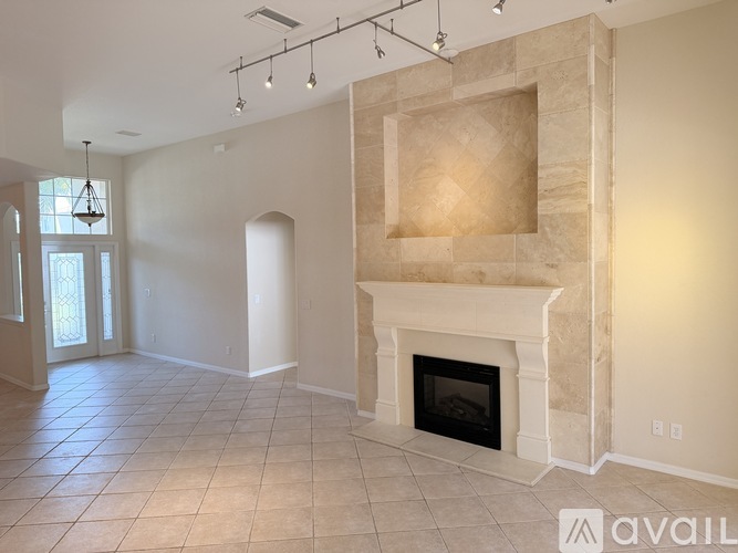 A living room with a fireplace and a tiled floor.