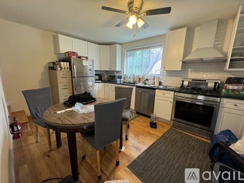 A kitchen with a table and chairs in the middle of it.