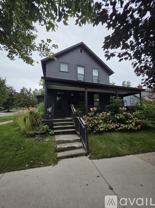 A house with a grey exterior and a front porch.