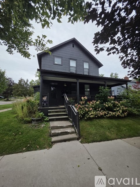A house with a grey exterior and a front porch.