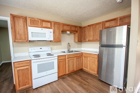 A kitchen with wooden cabinets and stainless steel appliances.