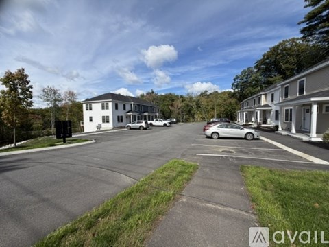 A parking lot with cars and apartment buildings in the background.