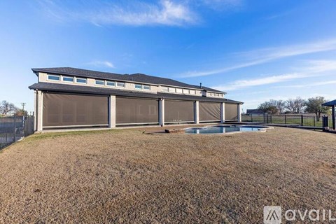 A large building with a pool in front of it.