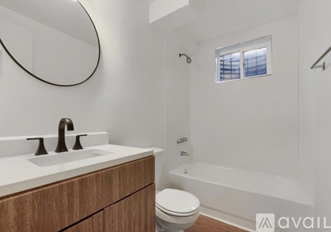 A bathroom with a white sink and a toilet.
