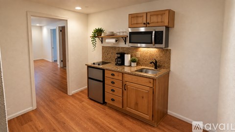 A kitchen with wooden cabinets and a granite countertop.