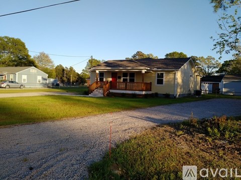 A house with a car parked in front of it.