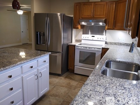 A kitchen with granite countertops and stainless steel appliances.