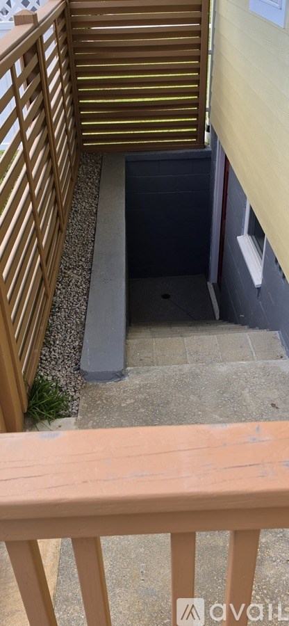 A wooden deck with a metal grate on the floor.