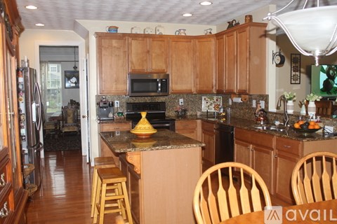 A kitchen with wooden cabinets and a granite countertop.